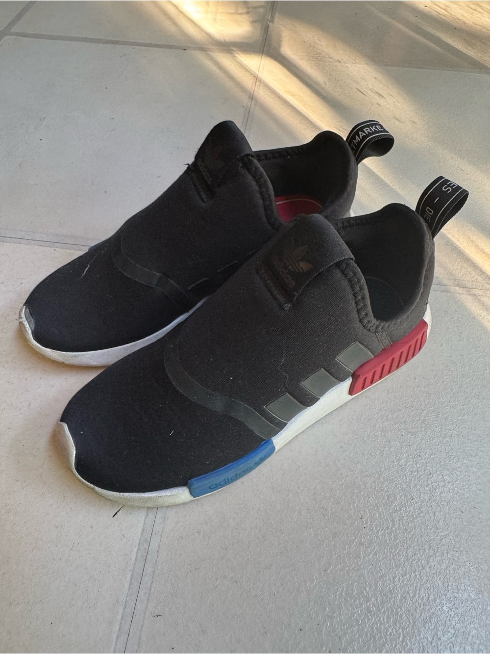adidas Kids Black Slip-On Sneakers with Red & Blue Midsole Accents